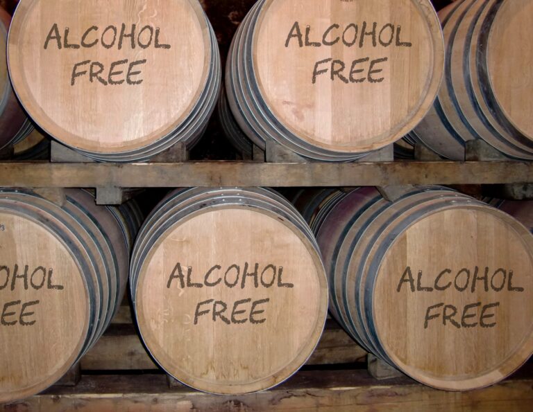 A row of wooden barrels with alcohol free written on them.